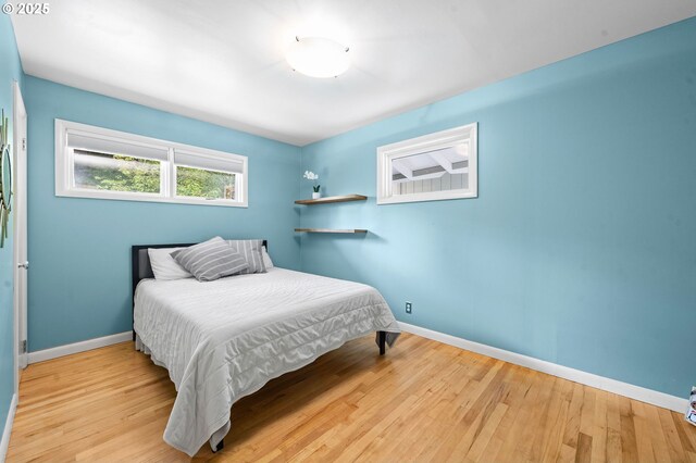 92757 Claremont Rd, Astoria, OR 97103 - bedroom featuring baseboards and wood finished floors