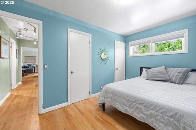 92757 Claremont Rd, Astoria, OR 97103 - bedroom featuring light wood-type flooring and baseboards