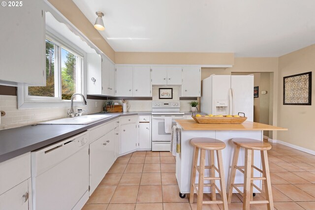 92757 Claremont Rd, Astoria, OR 97103 - kitchen with white appliances, a sink, light tile patterned floors, and tasteful backsplash