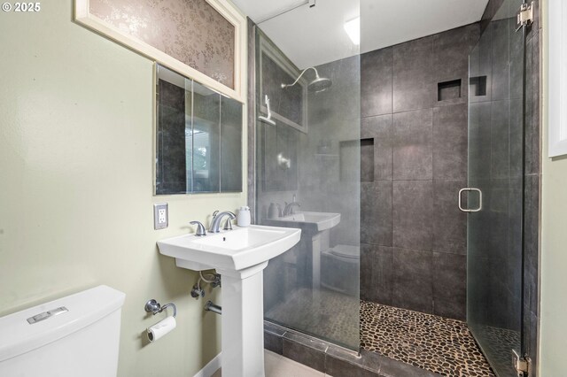 92757 Claremont Rd, Astoria, OR 97103 - bathroom featuring toilet, a stall shower, and a sink