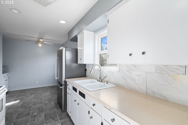 kitchen featuring sink, white cabinetry, electric range, stainless steel refrigerator, and ceiling fan