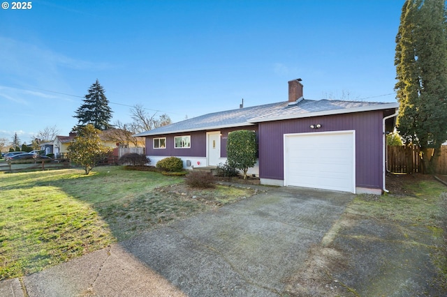 ranch-style home with a garage and a front lawn