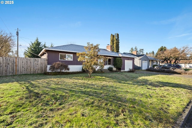 ranch-style house featuring a garage and a front yard