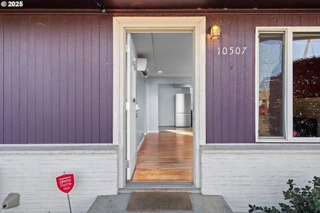 doorway to property featuring a wall mounted AC