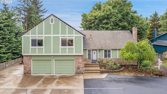 12143 SE Niklas Ln, Happy Valley, OR 97086 - view of front of home with asphalt driveway, brick siding, an attached garage, stucco siding, and a chimney