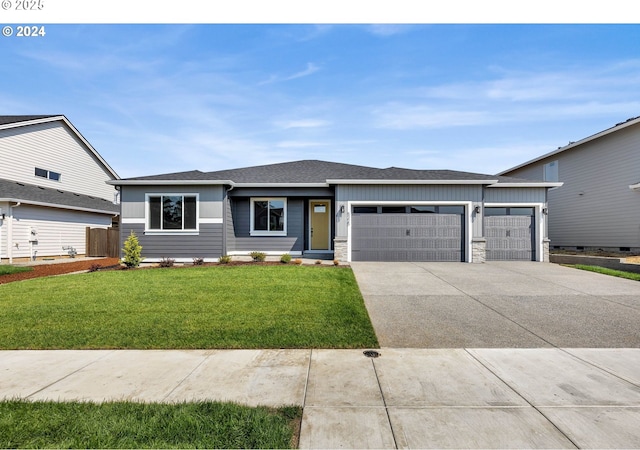 view of front of house featuring an attached garage, driveway, roof with shingles, and a front yard