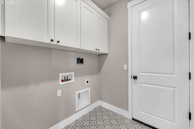 clothes washing area with cabinet space, baseboards, light floors, washer hookup, and electric dryer hookup