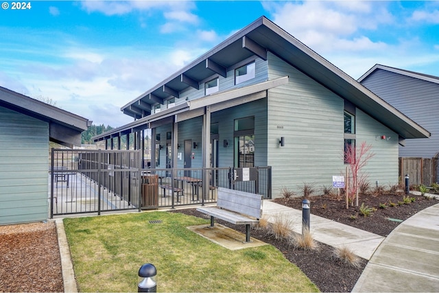 view of property exterior with a yard and fence