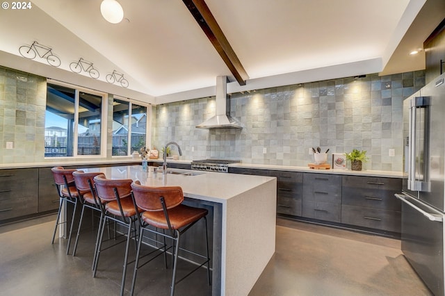 kitchen with high end refrigerator, a sink, finished concrete flooring, wall chimney range hood, and modern cabinets