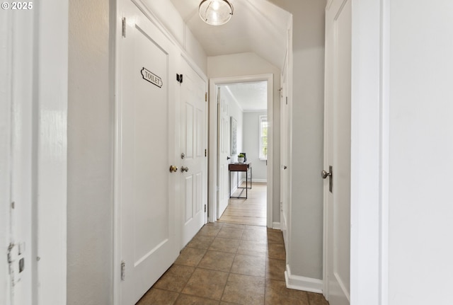 hall featuring baseboards
