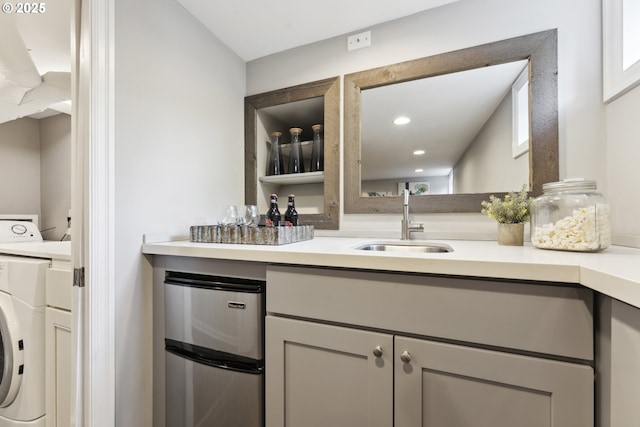 bathroom with washer / dryer, vanity, and recessed lighting