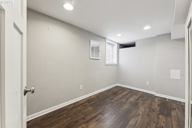 basement featuring dark wood finished floors, baseboards, and recessed lighting