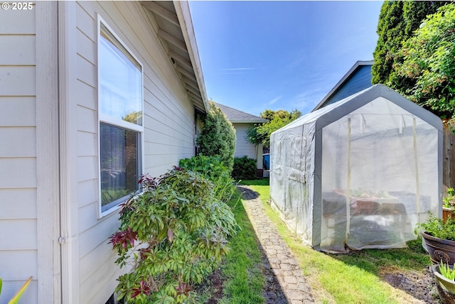 1506 E Heritage Loop, La Center, WA 98629 - view of side of home featuring a greenhouse and an outbuilding