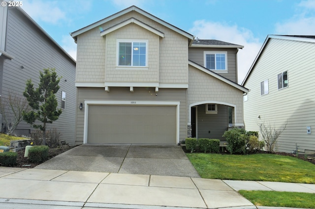 view of front of house with driveway, a front lawn, and a garage