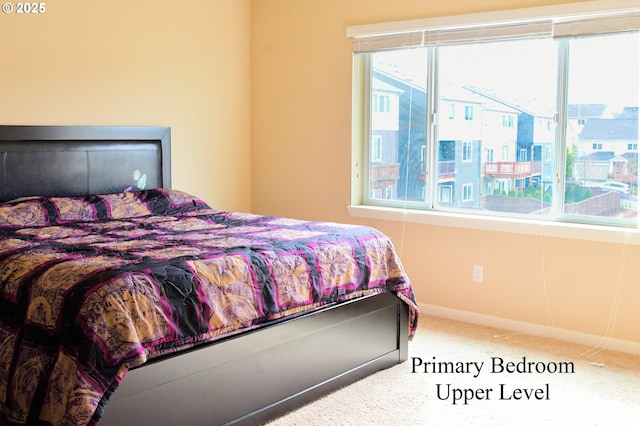 carpeted bedroom featuring baseboards