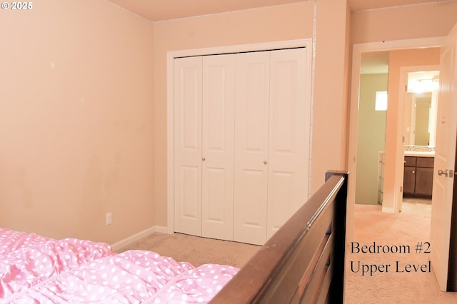 unfurnished bedroom featuring a closet, light colored carpet, and baseboards