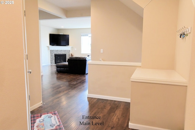 hallway featuring baseboards and dark wood-style flooring