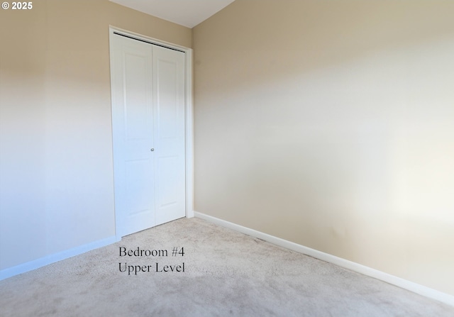 unfurnished bedroom with carpet, baseboards, and a closet