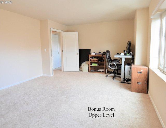 home office with baseboards and light colored carpet