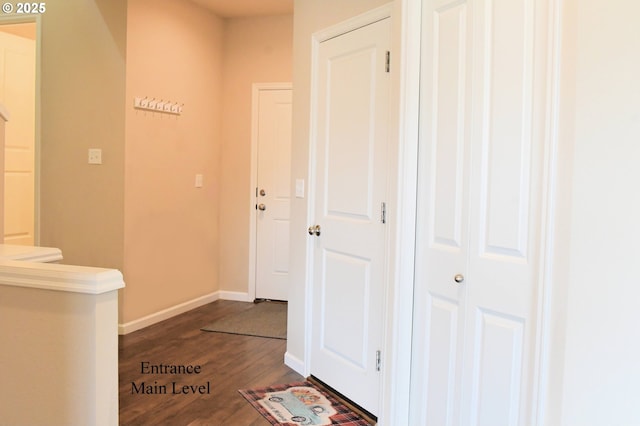 hall featuring dark wood finished floors and baseboards