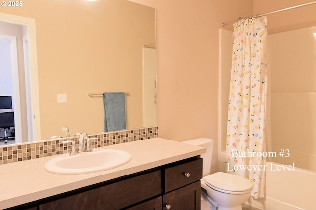 bathroom with vanity, backsplash, shower / tub combo, and toilet