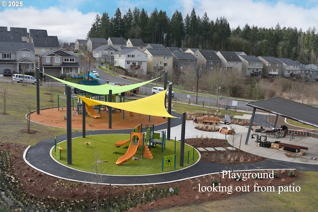 view of community featuring a lawn, playground community, and a residential view