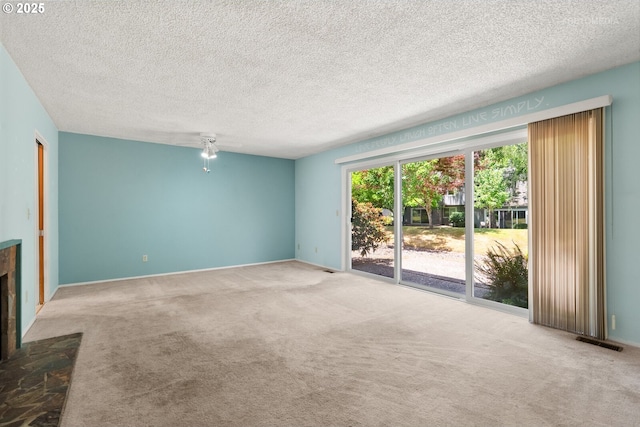 5312 SW Erickson Ave, Beaverton, OR 97005 - unfurnished living room featuring carpet floors, a fireplace with raised hearth, and a textured ceiling