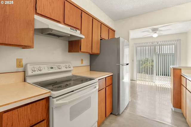 5312 SW Erickson Ave, Beaverton, OR 97005 - kitchen featuring white electric range oven, under cabinet range hood, light countertops, a ceiling fan, and freestanding refrigerator