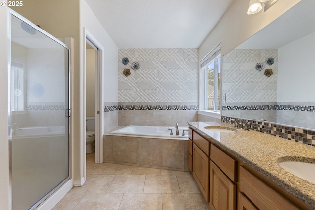 full bathroom featuring a shower stall, a garden tub, and toilet