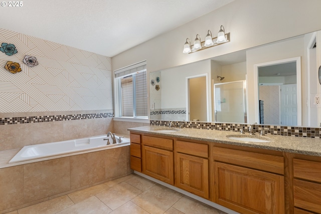 full bathroom with a tile shower, a bath, double vanity, and tile patterned floors