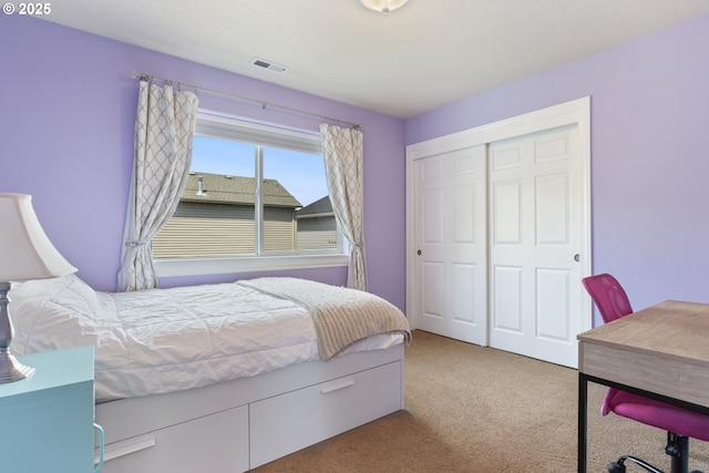 bedroom featuring carpet floors, a closet, and an office area