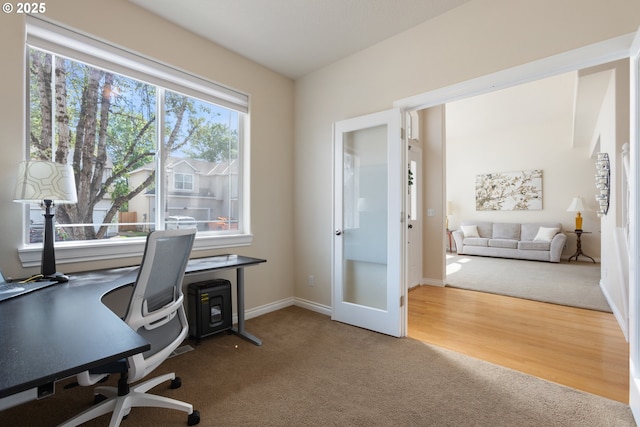 carpeted office featuring baseboards
