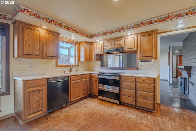 kitchen with sink, light parquet flooring, electric range, and black dishwasher