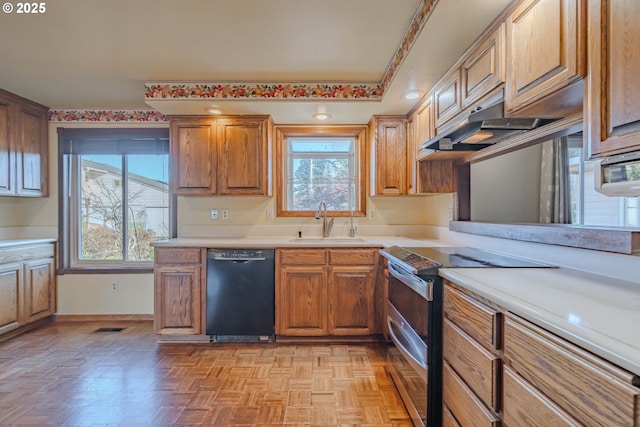 kitchen featuring stainless steel electric stove, ventilation hood, light parquet floors, sink, and black dishwasher