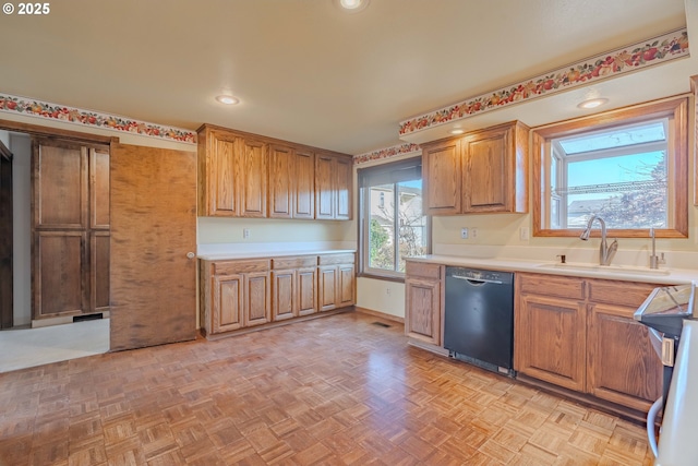 kitchen with sink, dishwasher, electric stove, and light parquet flooring