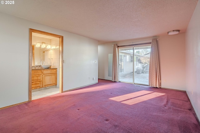 spare room with a textured ceiling and light carpet