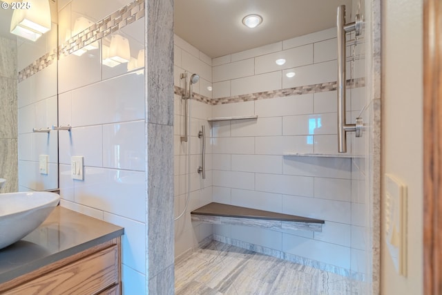 bathroom featuring vanity and tiled shower