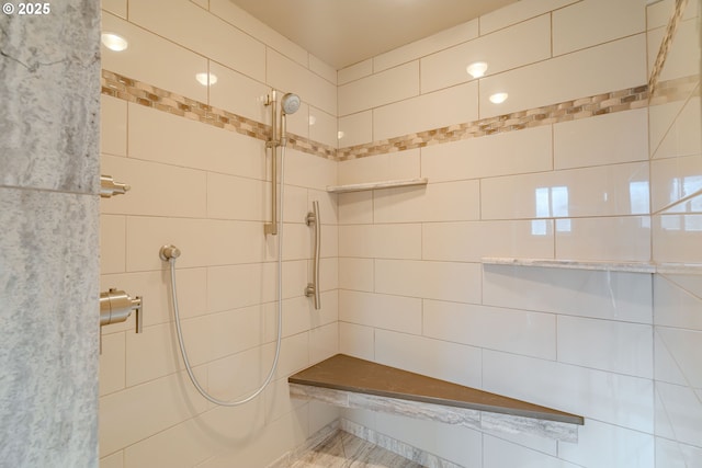 bathroom with a tile shower