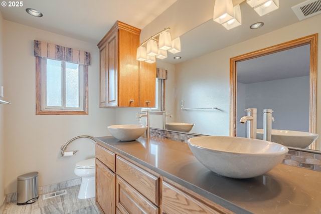 bathroom with vanity and toilet