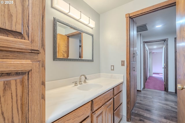 bathroom featuring vanity and wood-type flooring