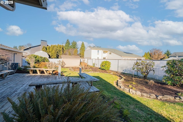 view of yard with a wooden deck and a storage shed