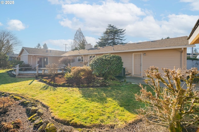 rear view of house featuring a lawn and a wooden deck