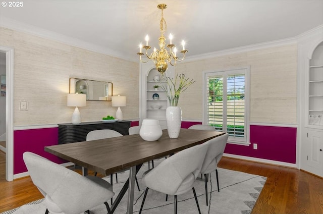 4326 SW Arthur Way, Portland, OR 97221 - dining space with ornamental molding, wood finished floors, a chandelier, baseboards, and arched walkways