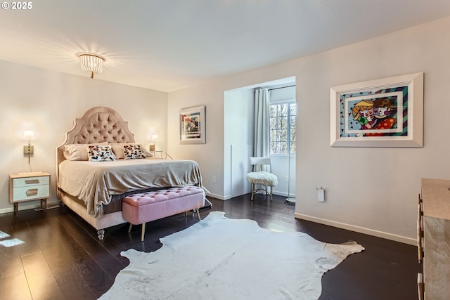 bedroom with dark hardwood / wood-style flooring