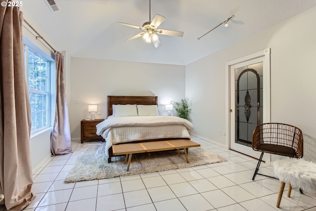 bedroom featuring light tile patterned floors and track lighting