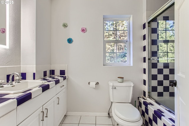 full bathroom with a healthy amount of sunlight, tile patterned floors, shower / bath combination with glass door, and toilet