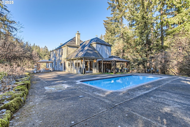 view of swimming pool with a gazebo and a patio area