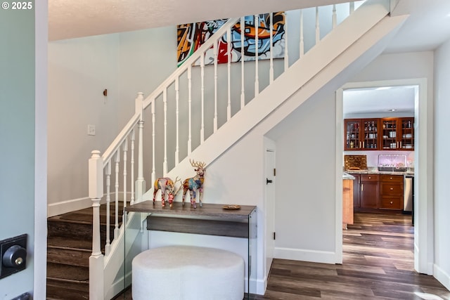 staircase with hardwood / wood-style floors