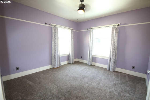 carpeted spare room featuring ceiling fan