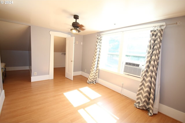 interior space with hardwood / wood-style flooring, ceiling fan, and cooling unit